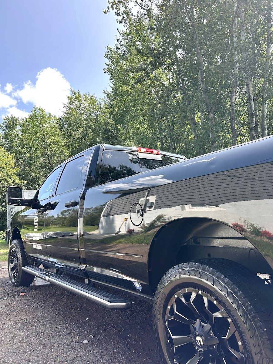 A black lifted Ram pickup, finished and clean,